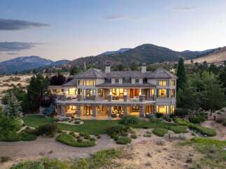 Experience luxury living in this expansive estate, nestled against a backdrop of majestic mountains.