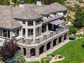 Experience luxury living in this stunning estate, featuring a multi-level design with expansive balconies and a covered patio perfect for entertaining.