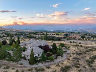 Experience luxury living with this stunning estate offering panoramic views of the city and surrounding mountains.