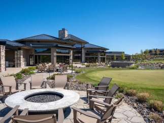 Experience luxury outdoor living with this stunning patio featuring a modern fire pit and comfortable seating, perfect for gatherings.