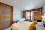 This charming bedroom features a spacious master bed and a twin bed, perfect for families or guests.