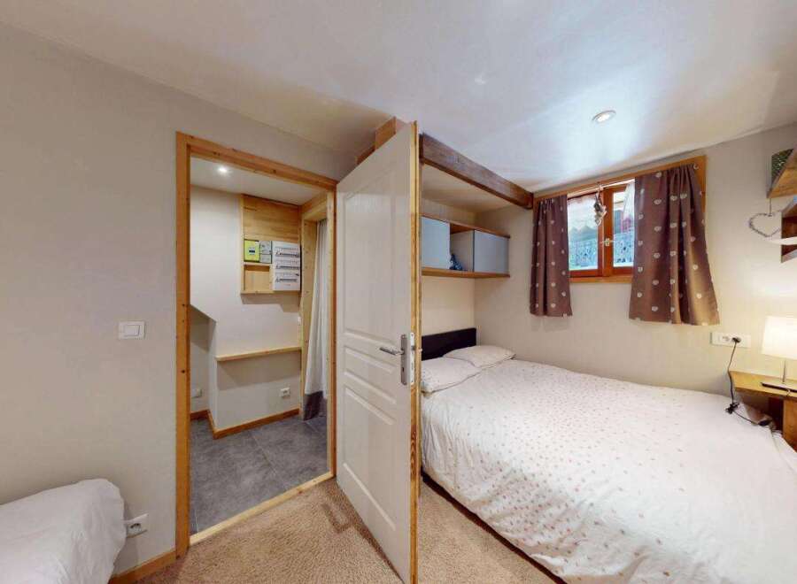 Discover this charming bedroom featuring a cozy single bed with a patterned duvet, perfect for a restful night's sleep.