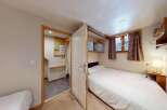 Discover this charming bedroom featuring a cozy single bed with a patterned duvet, perfect for a restful night's sleep.