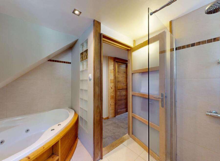 Indulge in relaxation with this luxurious bathroom featuring a spacious jacuzzi tub perfect for unwinding after a long day.