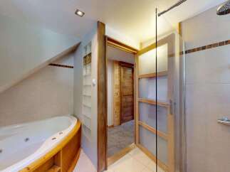 Indulge in relaxation with this luxurious bathroom featuring a spacious jacuzzi tub perfect for unwinding after a long day.
