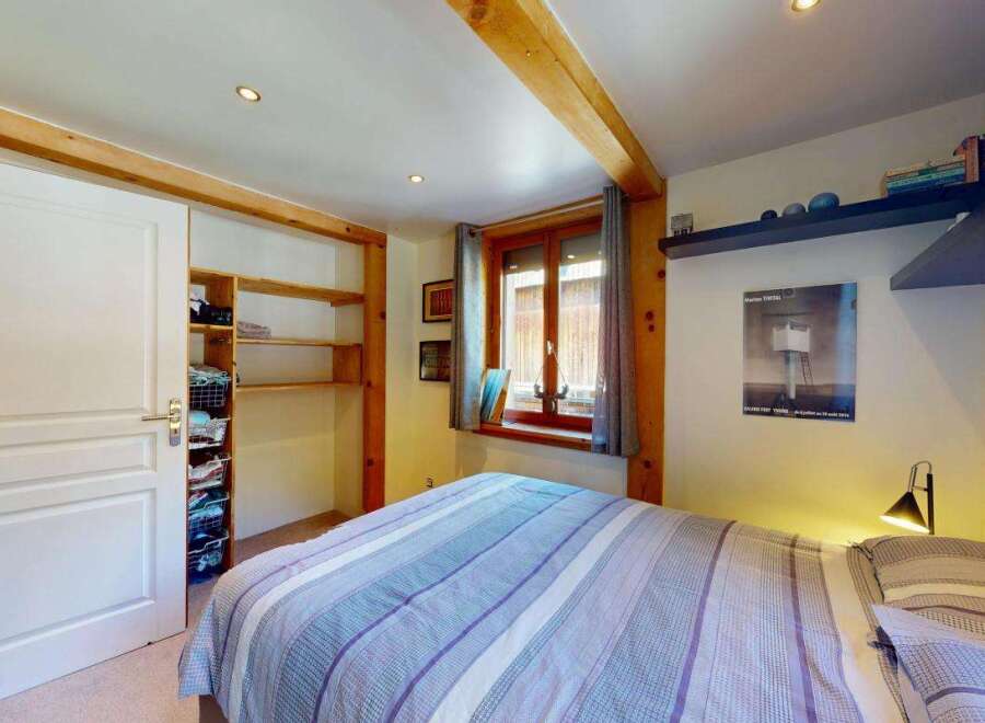 Discover this charming bedroom featuring a spacious sliding door closet with ample shelving and storage baskets.