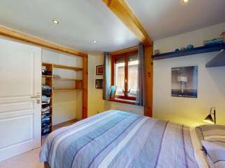 Discover this charming bedroom featuring a spacious sliding door closet with ample shelving and storage baskets.