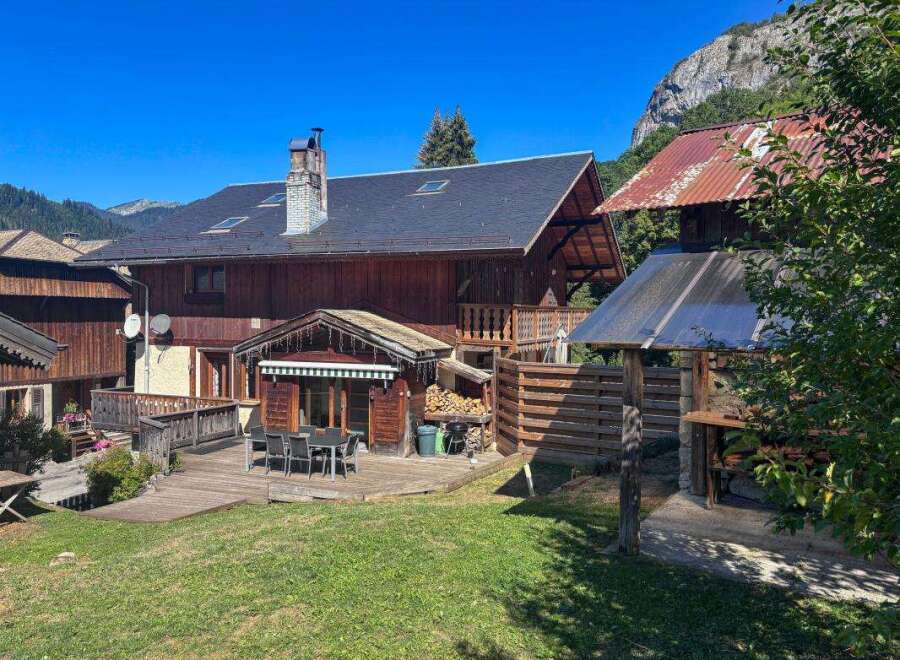 Experience mountain living in this charming wooden chalet, perfect for outdoor entertaining with its spacious deck and dining area.