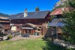 Experience mountain living in this charming wooden chalet, perfect for outdoor entertaining with its spacious deck and dining area.