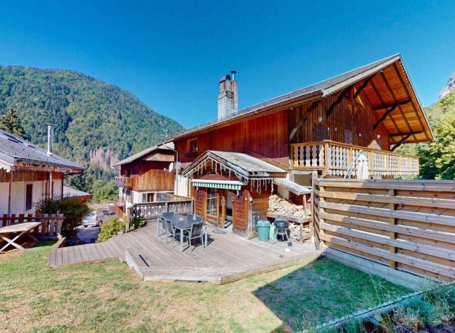 Experience mountain living in this charming wooden chalet, featuring a spacious outdoor deck perfect for entertaining or enjoying the serene surroundings.