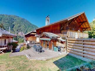 Experience mountain living in this charming wooden chalet, featuring a spacious outdoor deck perfect for entertaining or enjoying the serene surroundings.