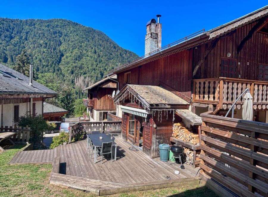 Experience mountain living in this charming wooden chalet, featuring a spacious outdoor deck perfect for al fresco dining and enjoying the scenic views.