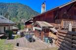 Experience mountain living in this charming wooden chalet, featuring a spacious outdoor deck perfect for al fresco dining and enjoying the scenic views.