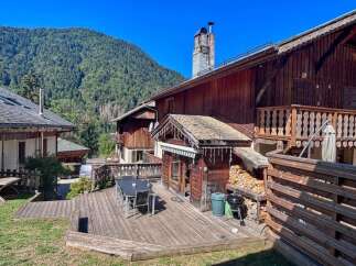 Experience mountain living in this charming wooden chalet, featuring a spacious outdoor deck perfect for al fresco dining and enjoying the scenic views.