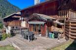 Enjoy outdoor living on this expansive wooden deck, perfect for entertaining or relaxing amidst stunning mountain views.