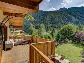 Enjoy breathtaking mountain views from this charming wooden deck, perfect for relaxing or entertaining.