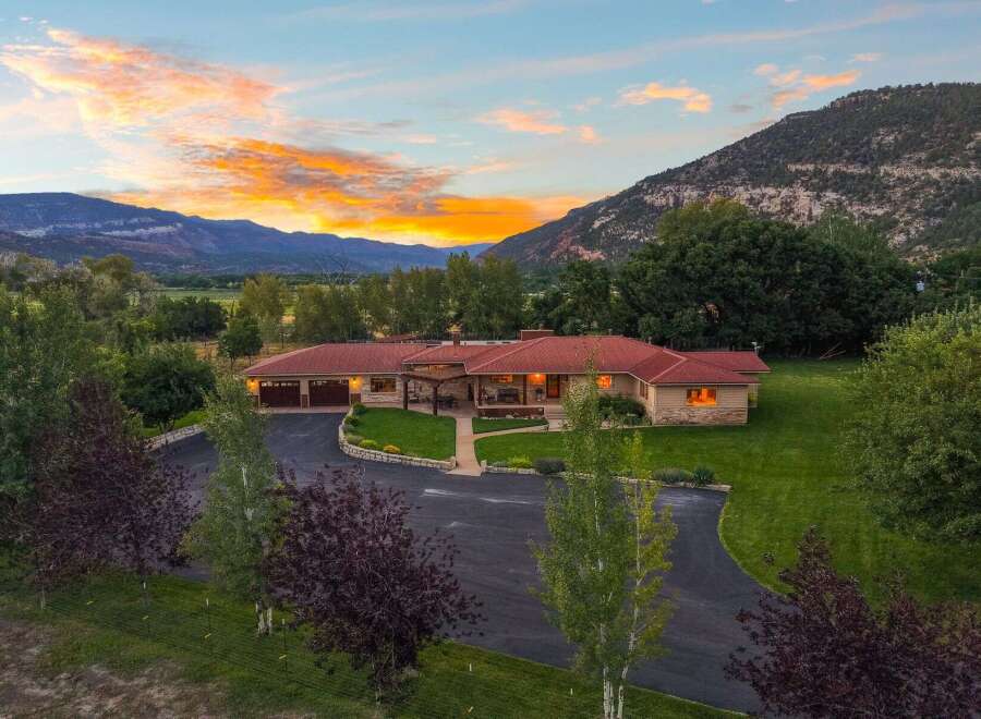 Experience breathtaking mountain views from this stunning ranch-style home, perfectly situated at the base of majestic peaks.