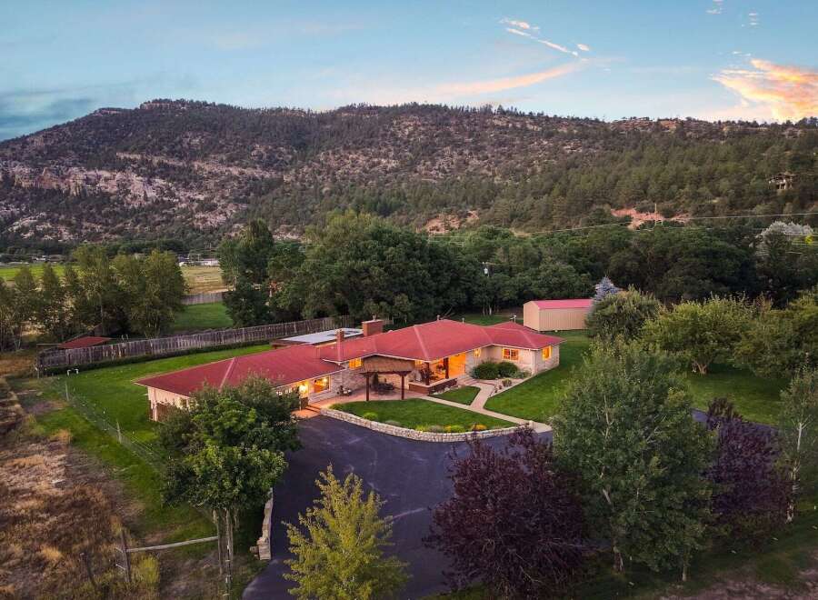 Experience serene living in this stunning property nestled against a majestic mountain backdrop.
