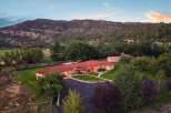 Experience serene living in this stunning property nestled against a majestic mountain backdrop.