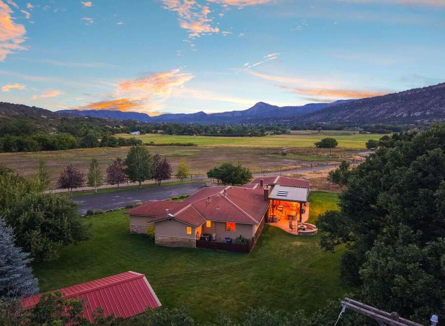 Experience serene country living with this stunning property, featuring a spacious home with a welcoming covered patio and a cozy fire pit, perfect for enjoying the breathtaking mountain views.