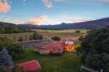 Experience serene country living with this stunning property, featuring a spacious home with a welcoming covered patio and a cozy fire pit, perfect for enjoying the breathtaking mountain views.