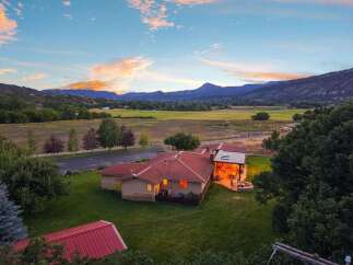 Experience serene country living with this stunning property, featuring a spacious home with a welcoming covered patio and a cozy fire pit, perfect for enjoying the breathtaking mountain views.