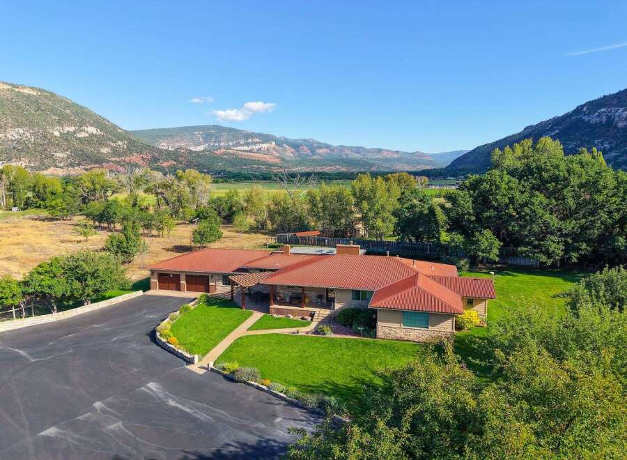 Nestled amidst breathtaking mountain scenery, this expansive ranch-style home offers a serene retreat.