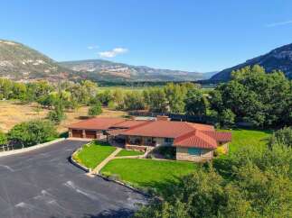 Nestled amidst breathtaking mountain scenery, this expansive ranch-style home offers a serene retreat.