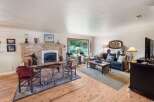 This inviting living room features a stunning stone fireplace as the focal point, perfect for cozy evenings.
