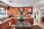 Discover this beautifully appointed kitchen featuring rich cherry wood cabinetry and elegant granite countertops.