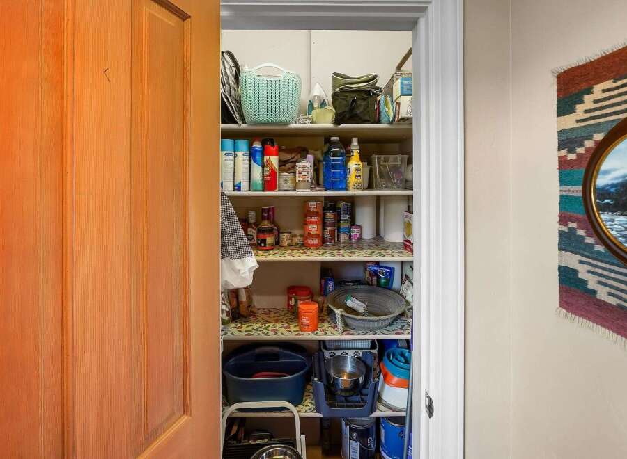 Discover ample storage solutions in this charming pantry, perfect for organizing your home essentials.