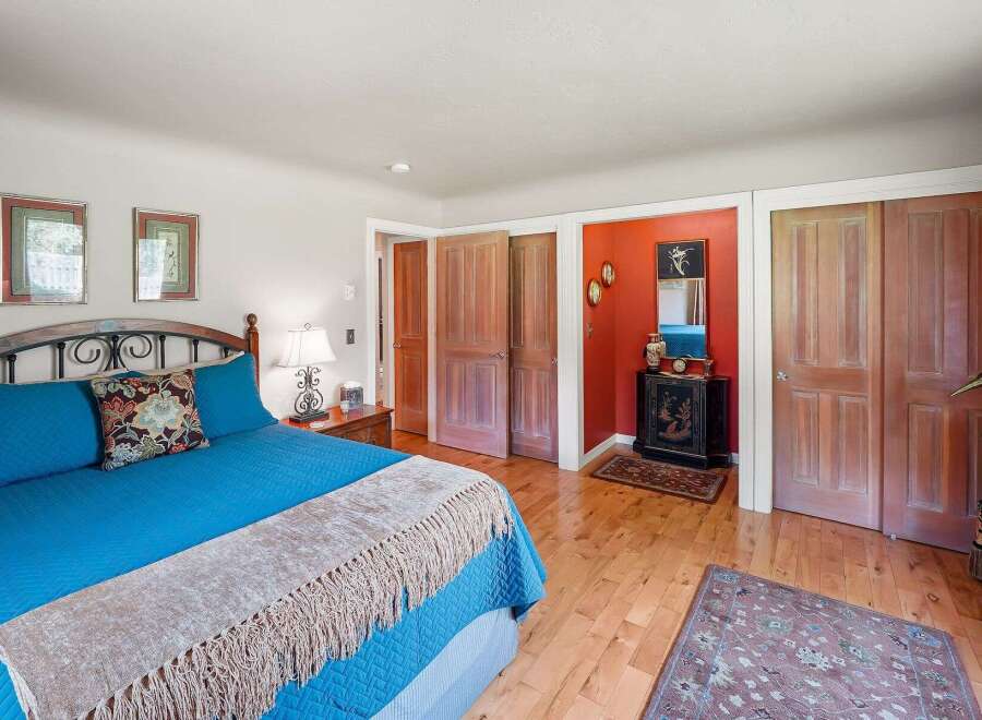This charming bedroom features a comfortable king-sized bed with vibrant blue bedding and a decorative accent pillow.