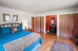 This charming bedroom features a comfortable king-sized bed with vibrant blue bedding and a decorative accent pillow.