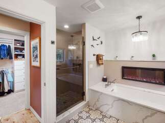 Experience luxury and comfort in this stunning master bathroom, featuring a spacious walk-in closet and a spa-like soaking tub.