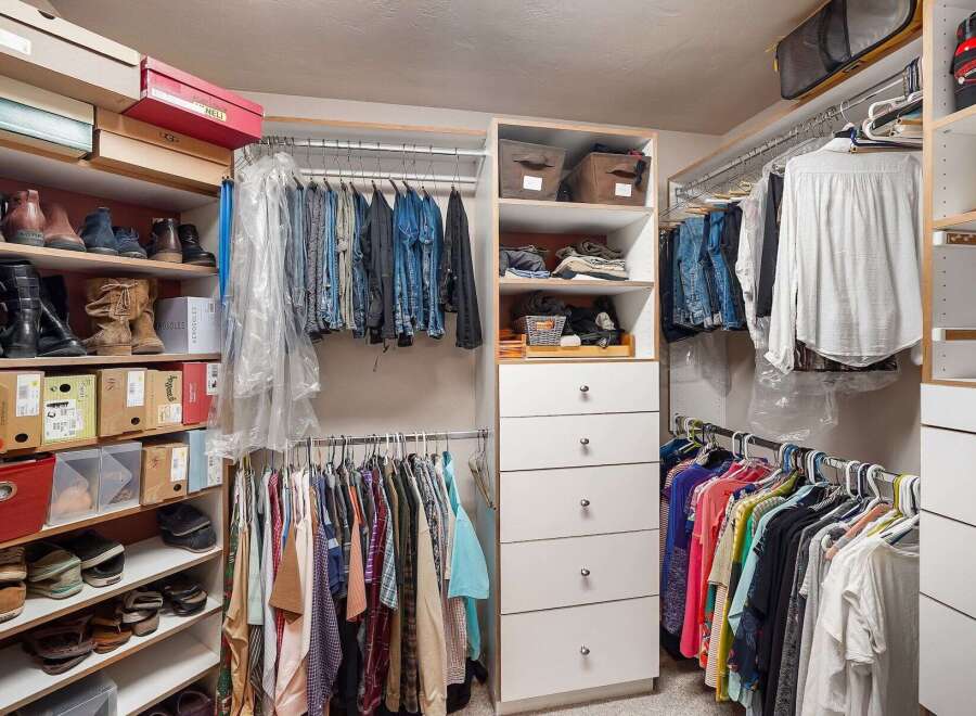 Discover an impeccably organized walk-in closet designed for ultimate convenience.