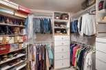 Discover an impeccably organized walk-in closet designed for ultimate convenience.