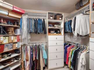 Discover an impeccably organized walk-in closet designed for ultimate convenience.