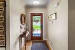 Step into this charming entryway featuring a beautiful glass-paneled door that floods the space with natural light.