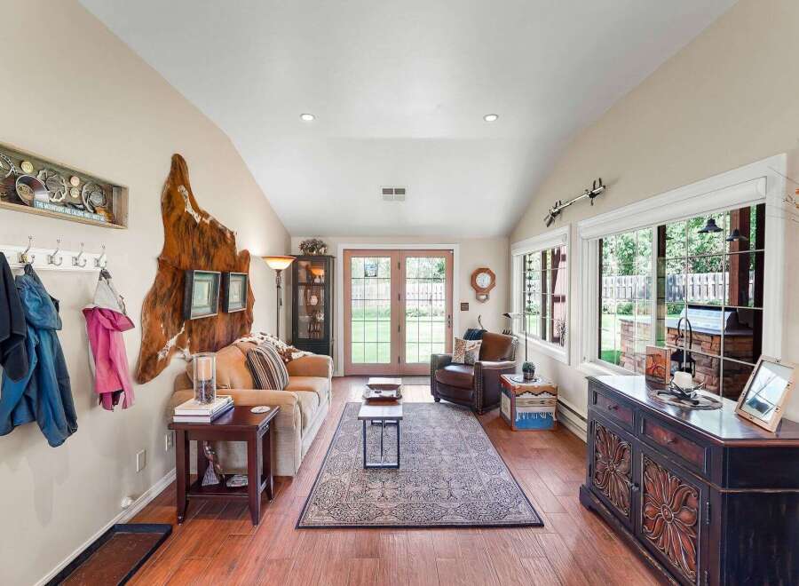 Step into this inviting living room, featuring a cozy sofa and a plush armchair perfect for relaxation.