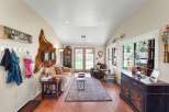Step into this inviting living room, featuring a cozy sofa and a plush armchair perfect for relaxation.