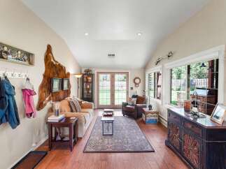 Step into this inviting living room, featuring a cozy sofa and a plush armchair perfect for relaxation.