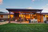 Enjoy outdoor living at its finest with this expansive covered patio, complete with a built-in stone grill and ample seating.