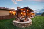 Experience ultimate outdoor living with this stunning backyard oasis, featuring a curved stone fire pit area perfect for cozy evenings.
