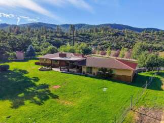 Discover this stunning property nestled against a scenic hillside, offering a perfect blend of indoor and outdoor living.