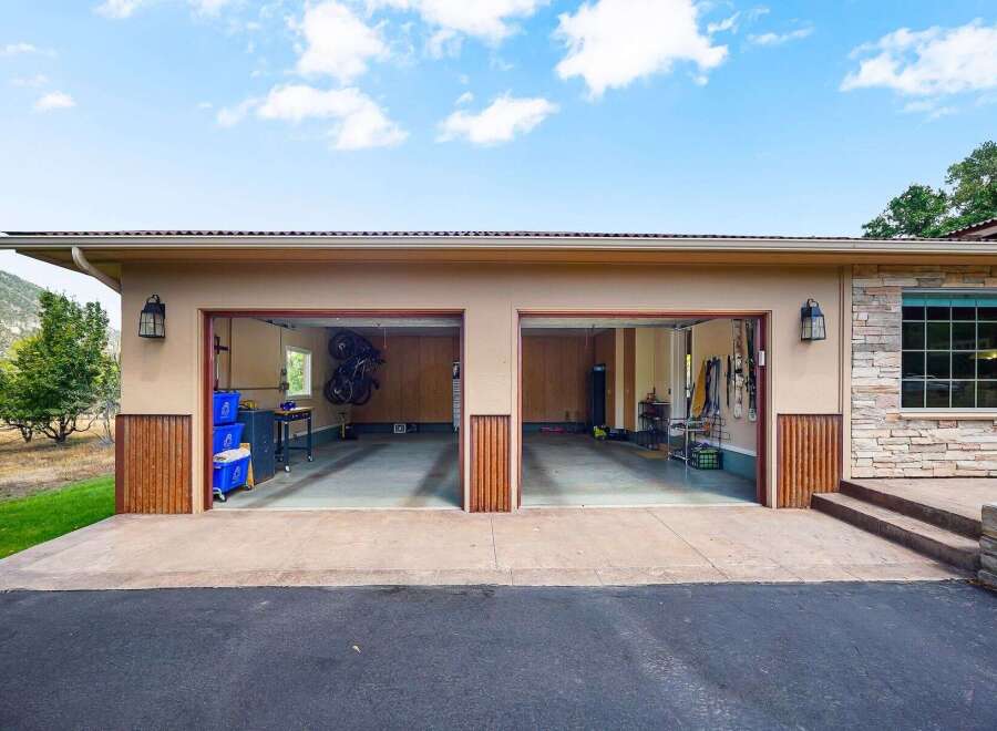 This spacious garage features two large bays, perfect for storing vehicles or setting up a workshop.