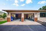 This spacious garage features two large bays, perfect for storing vehicles or setting up a workshop.