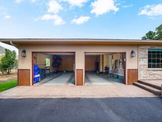 This spacious garage features two large bays, perfect for storing vehicles or setting up a workshop.