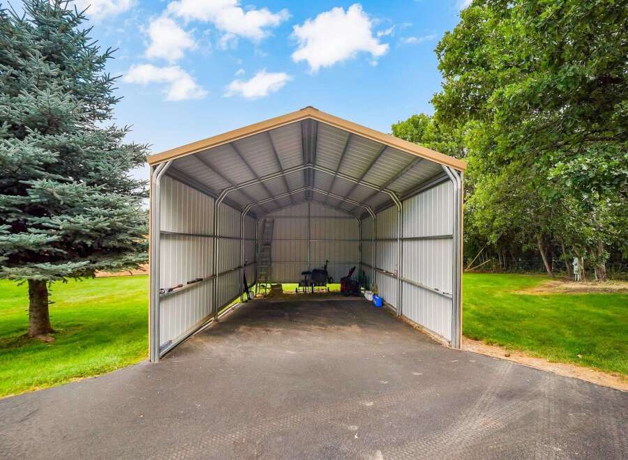 Discover ample storage and protection with this spacious metal carport, perfect for housing vehicles, equipment, or recreational gear.