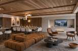 Experience luxurious mountain living in this stunning open-concept space, featuring a modern dining area with seating for ten and a cozy living room with a fireplace and entertainment center.
