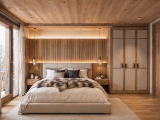 Experience rustic luxury in this stunning bedroom, featuring a cozy king-sized bed adorned with a plush fur throw and a textured headboard.